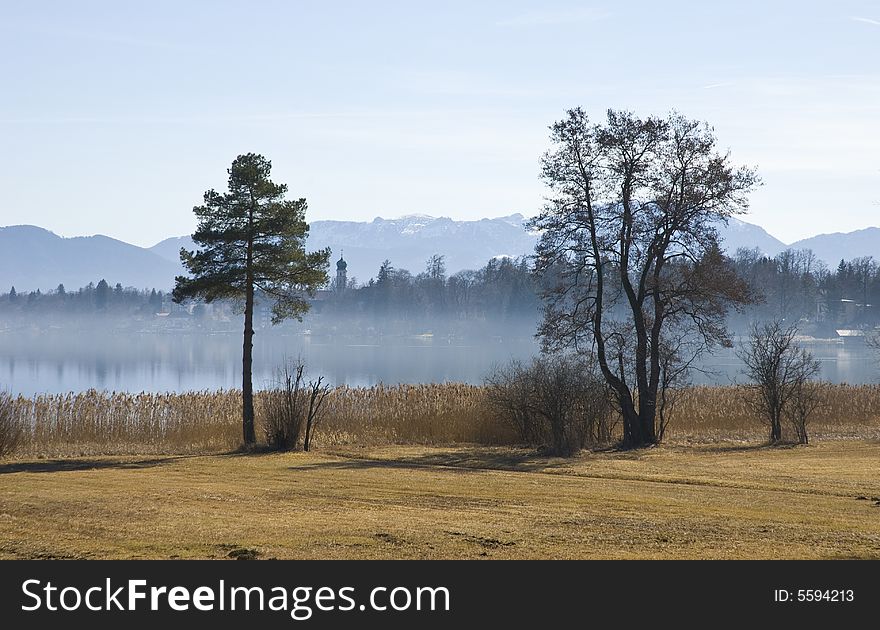 Little village at the shore of Lake Starnberg in light morning mist. Little village at the shore of Lake Starnberg in light morning mist