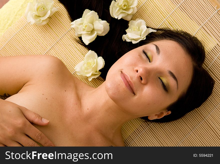 Attractive brunette woman relaxing in massage. Attractive brunette woman relaxing in massage