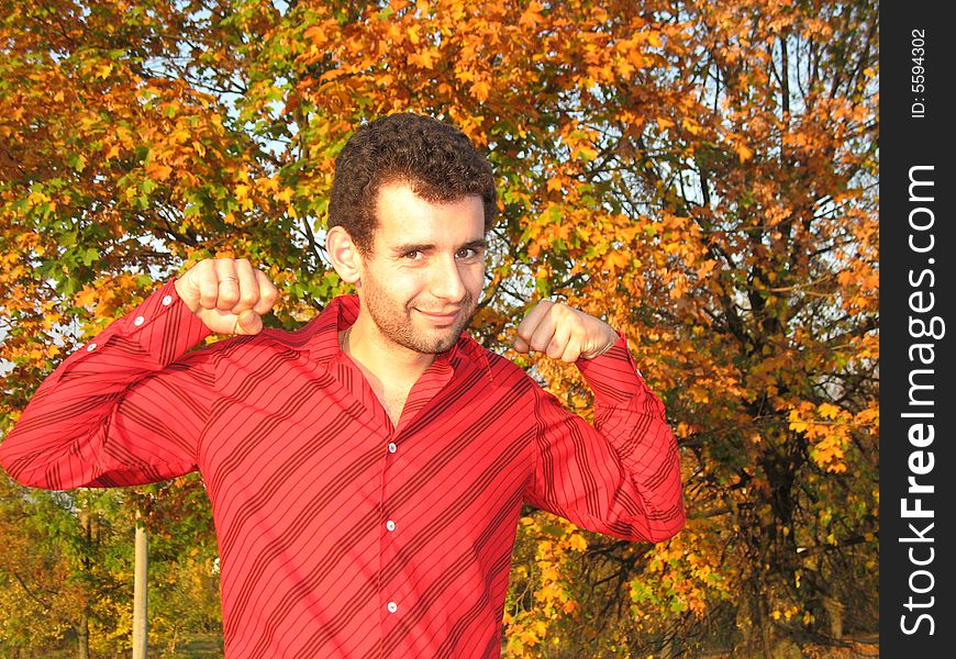 The young man is exercising in the park. The young man is exercising in the park