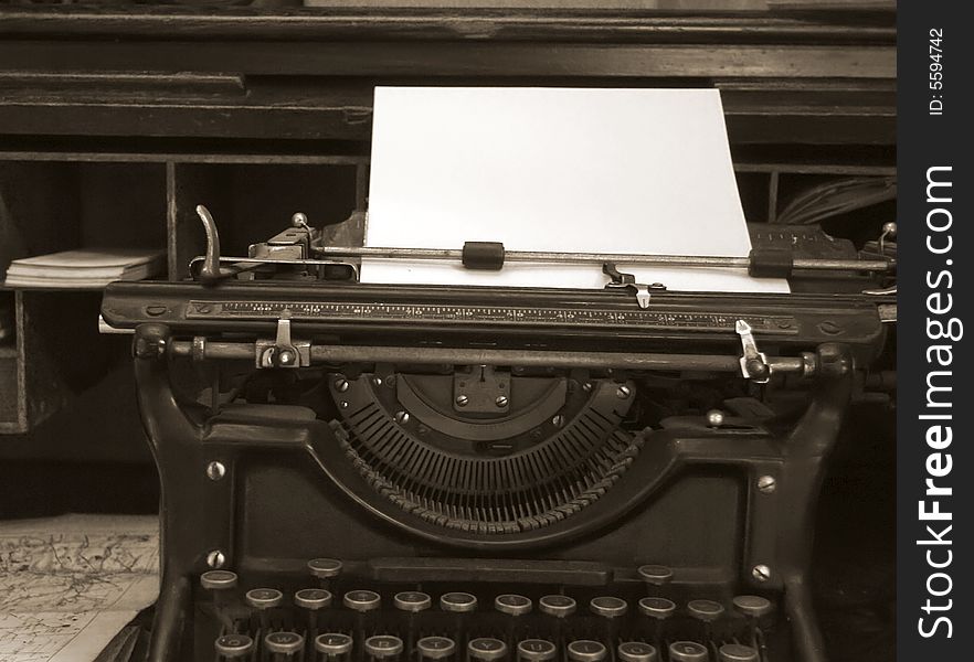 Sepia toned image of old typewriter and desk
