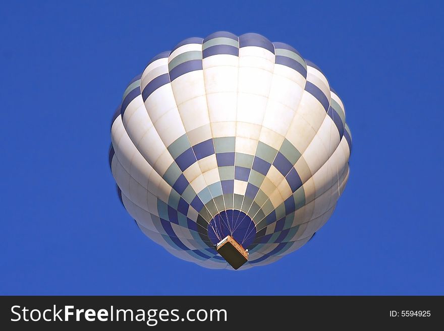 A Hot Air Balloon on an clear morning flight.  Space for copy.