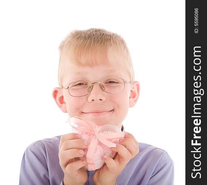 Portrait of smiling young boy take a gift in a nice pink heart shaped box isolated on white. Portrait of smiling young boy take a gift in a nice pink heart shaped box isolated on white.