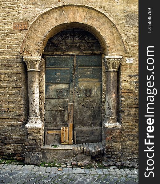 Ancient door with columns in Fermo (Italy)