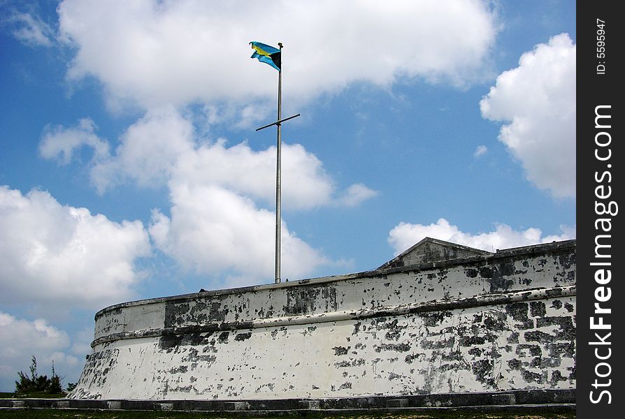 The Bahamian flag and Charlotte Fort in Nassau town, the capital of The Bahamas.