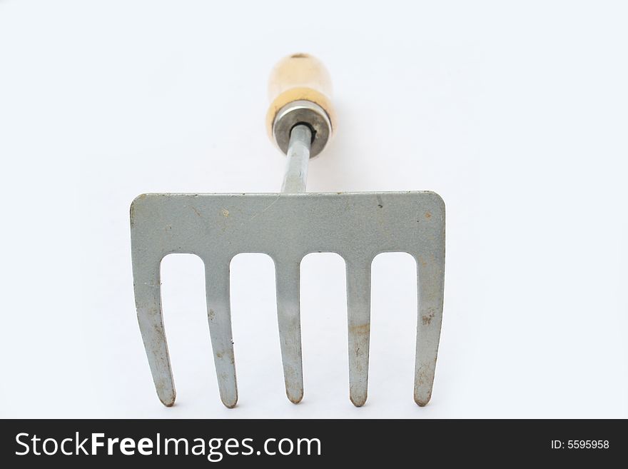 Hand rake on white background with shallow depth of field