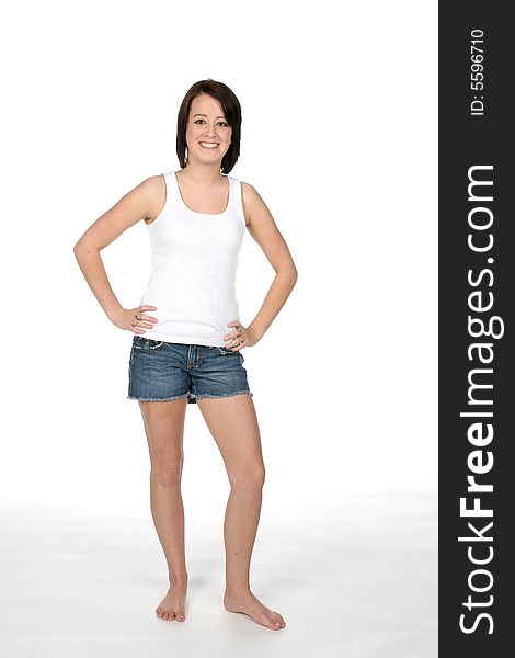 Pretty teenage girl in shorts and white tank top. Pretty teenage girl in shorts and white tank top