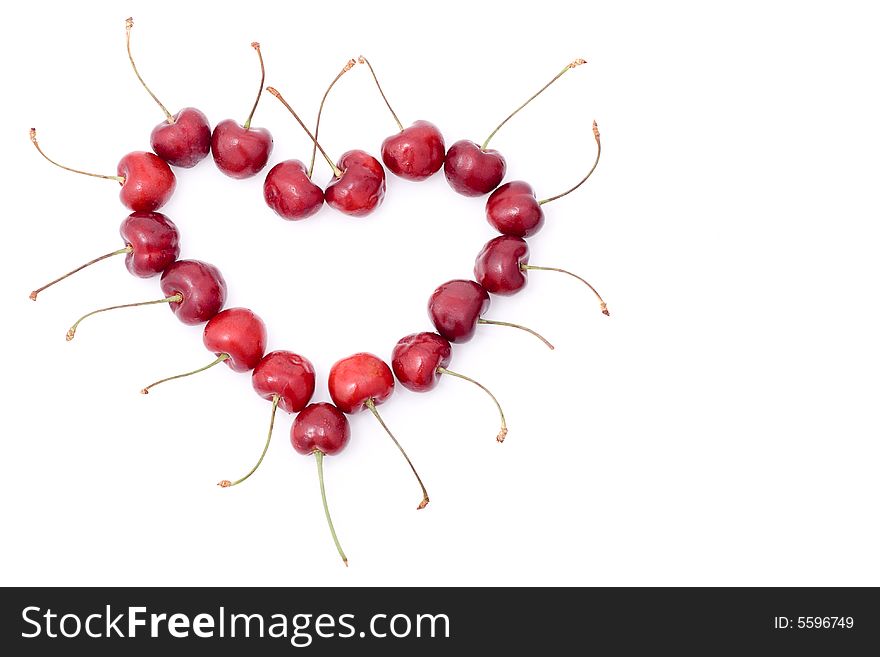 Red shape heart from sweet cherry with white background, left handed position, copy space for the text