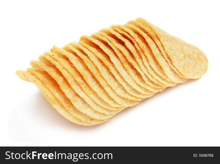 Potato chips stacked together on white background.