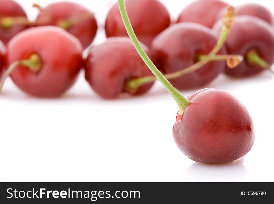 Macro sweet cherries with one cherry at front side, low deep of field, copy space for the text