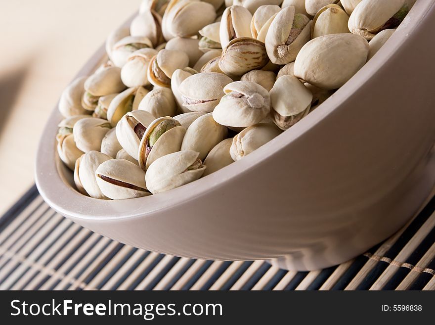 Salty pistachio in plate close up