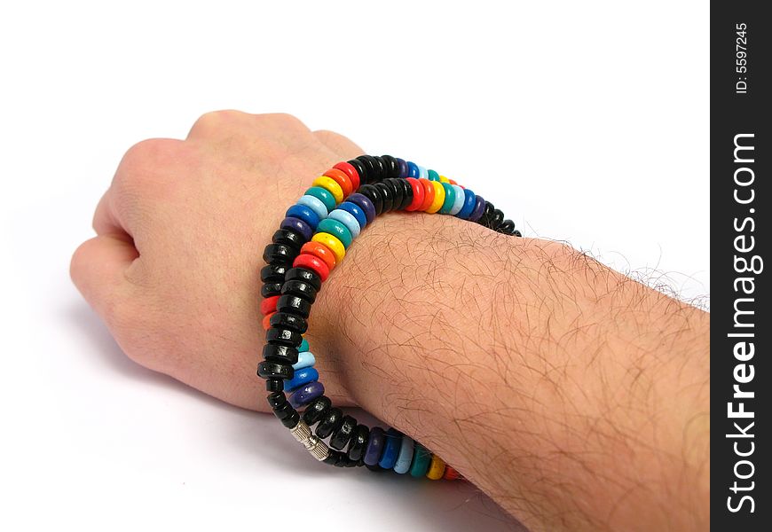 Painted wood necklace on a hand, in a white background. Painted wood necklace on a hand, in a white background