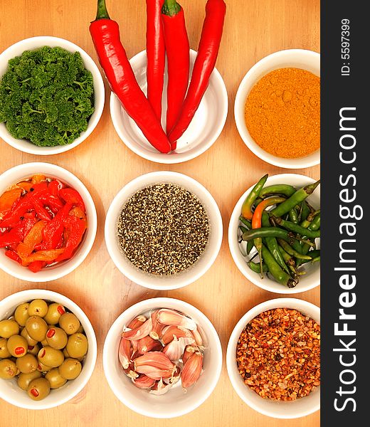 Nine dishes with an assortment of spices and herbs. Nine dishes with an assortment of spices and herbs