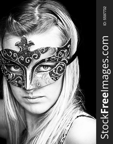 Masked blond woman in black and white. Masked blond woman in black and white