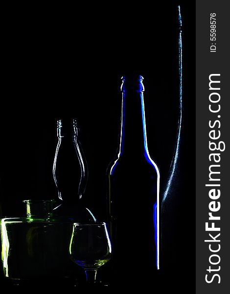 An image of glasses bottles on black background. An image of glasses bottles on black background
