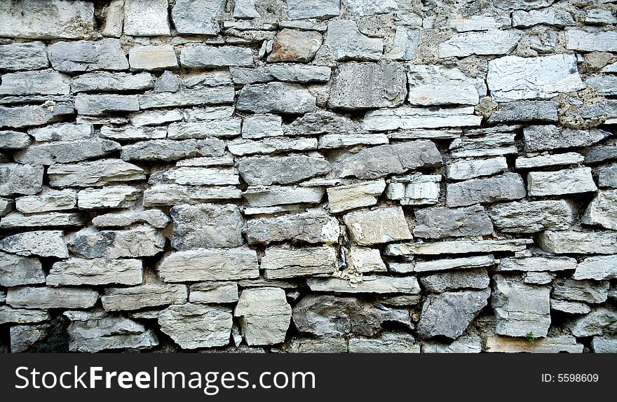 An image of grey stone wall. Close up. An image of grey stone wall. Close up.