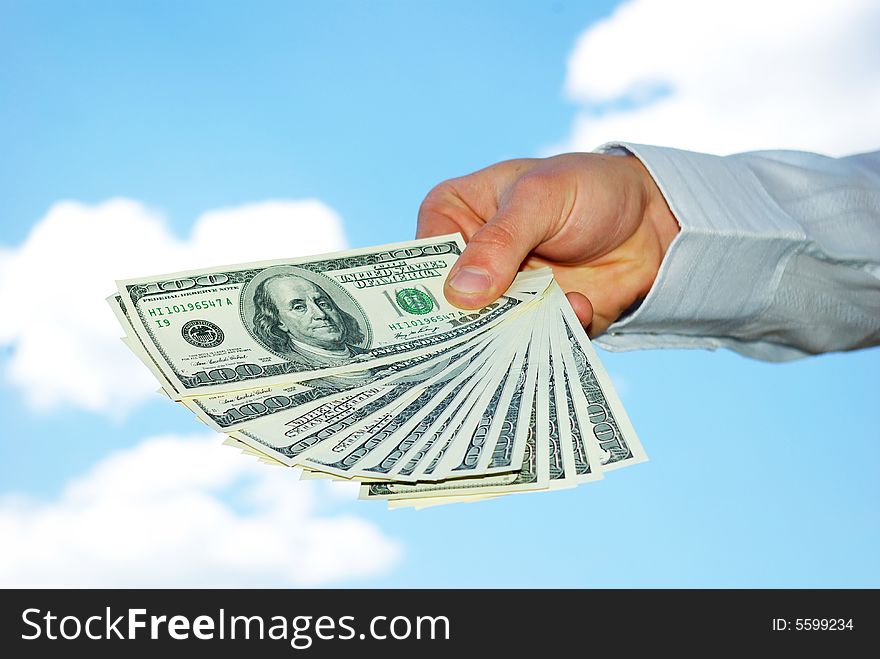 Money in hand  isolated on sky background