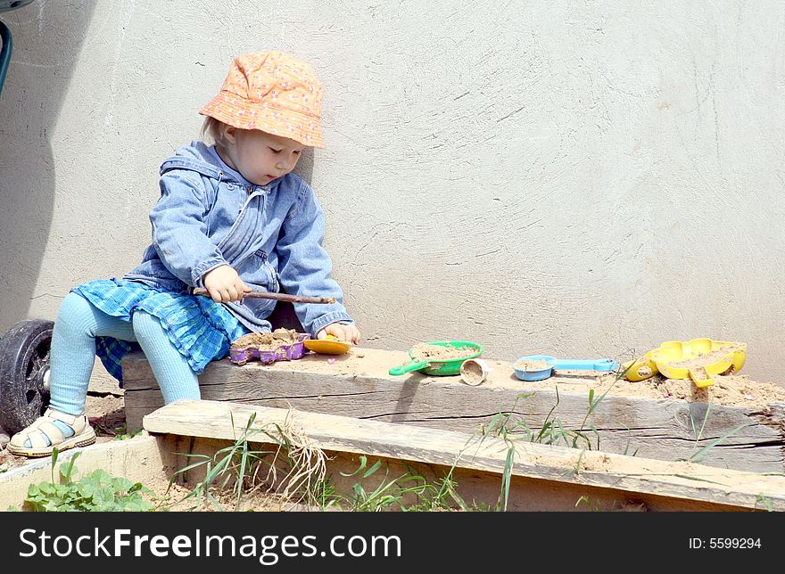 A girl playing in the sand box. A girl playing in the sand box