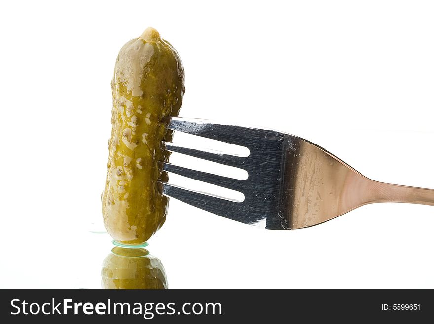 Crackling pickled gherkins on a plug on a white background