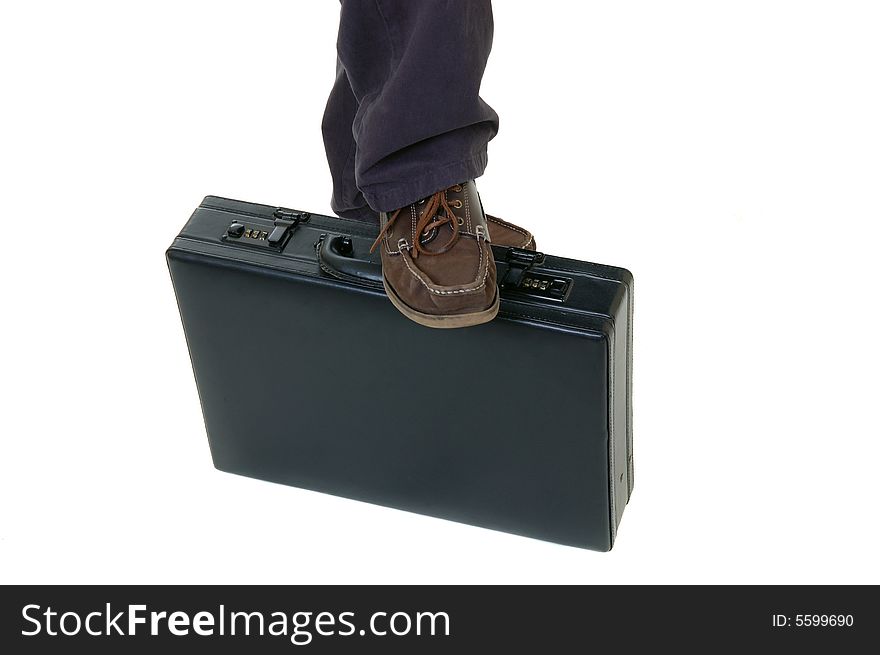Black briefcase with foot resting on, over white, studio shot. Black briefcase with foot resting on, over white, studio shot