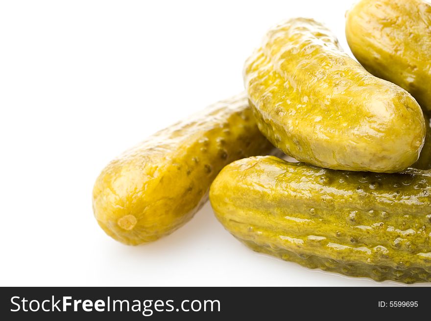 Crackling pickled gherkins on a white background