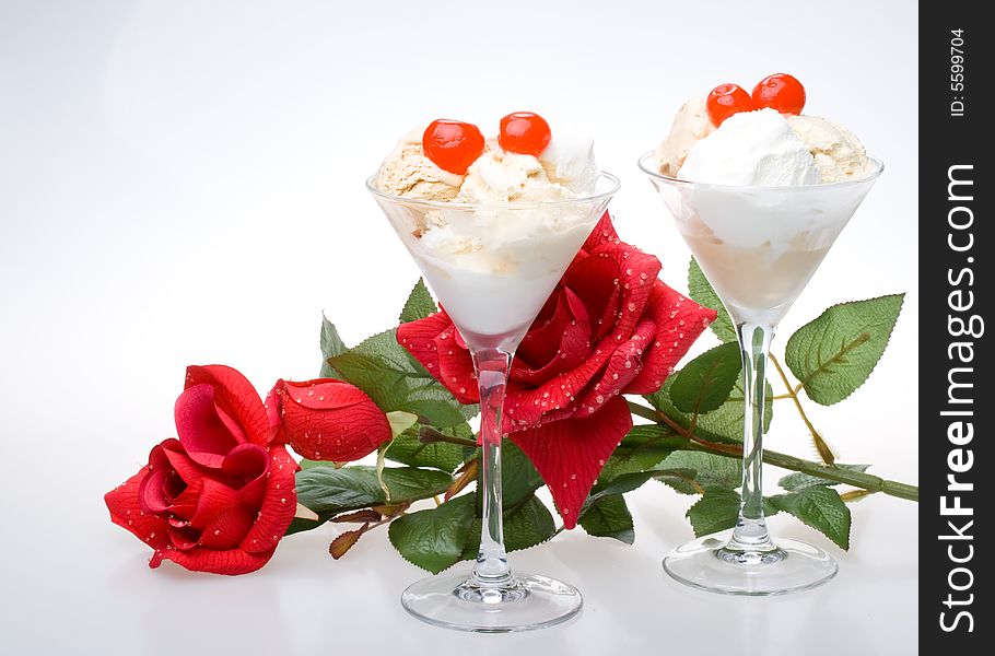 Ice-cream with a cherry in a glass on a white background. Ice-cream with a cherry in a glass on a white background.