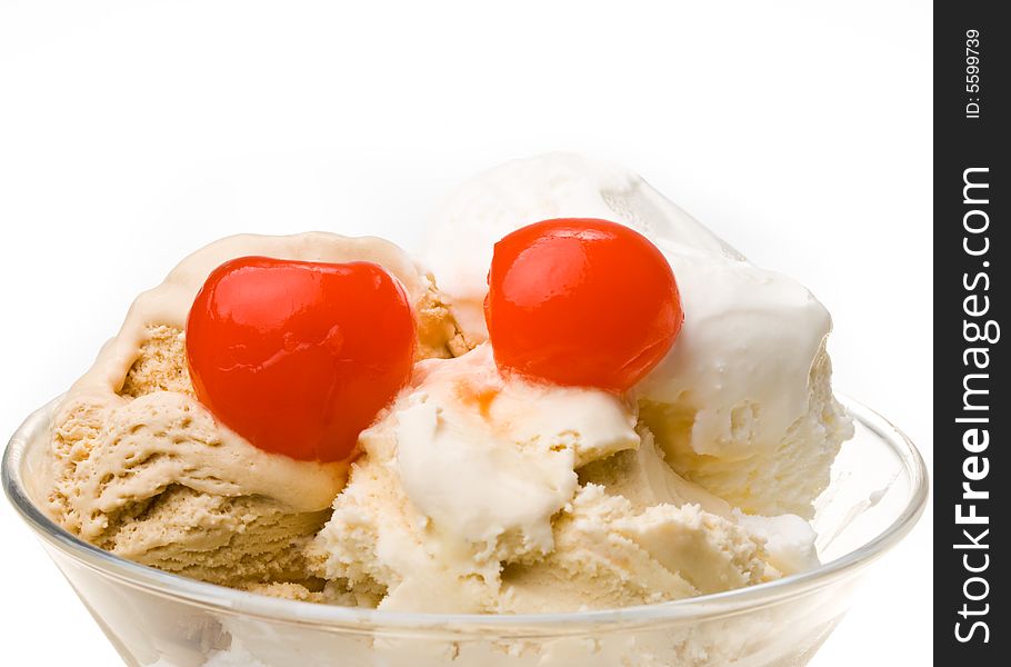 Ice-cream with a cherry in a glass on a white background. Ice-cream with a cherry in a glass on a white background.