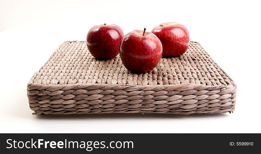 Three red apples on white background