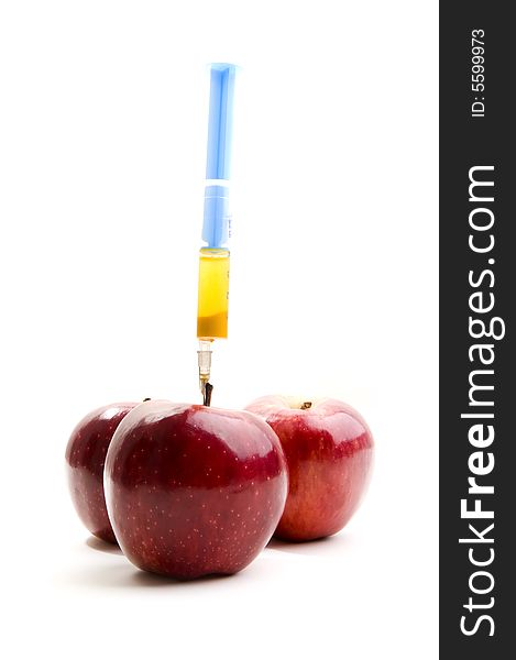 Red apples with syringe on white background. Red apples with syringe on white background