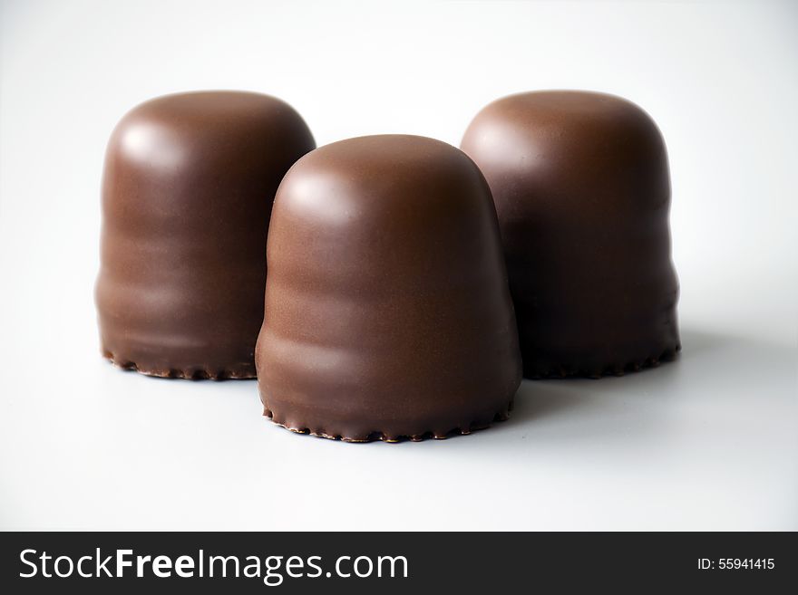 Marshmallows in chocolate with soft grey background