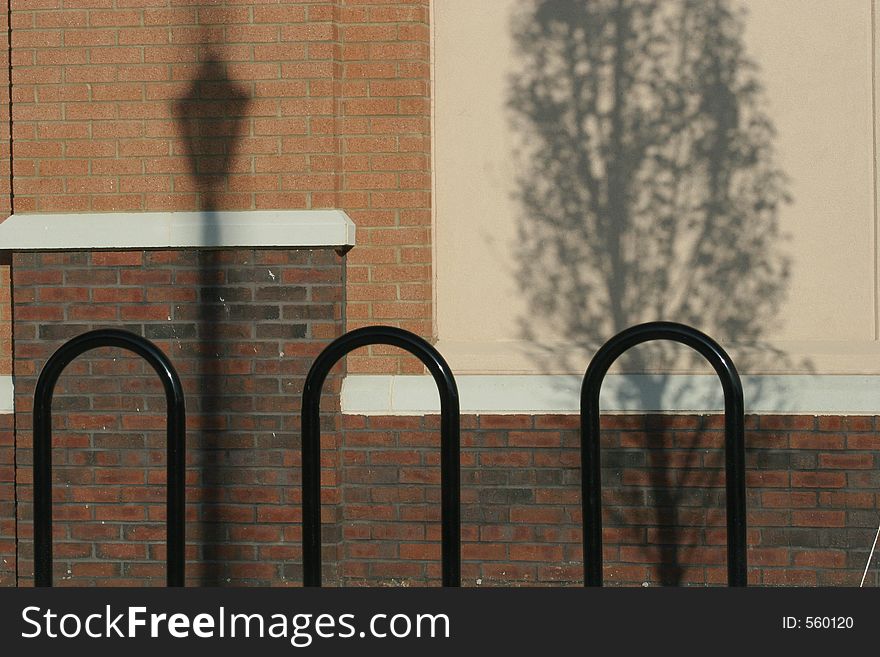 Black bars against wall with shadows. Black bars against wall with shadows