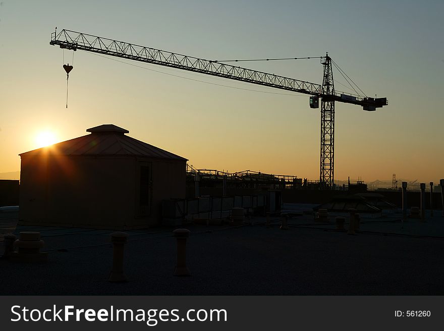 Crane and building silouette at sunset. Crane and building silouette at sunset