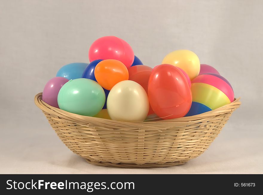 Plastic Easter eggs in a wicker basket.