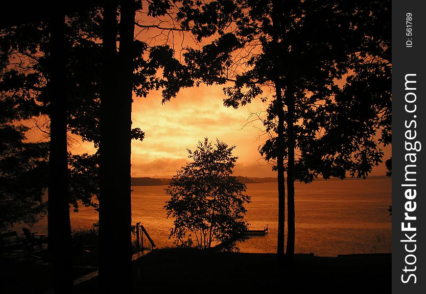 Vivid sunset on lake after a thunder storm. Vivid sunset on lake after a thunder storm.