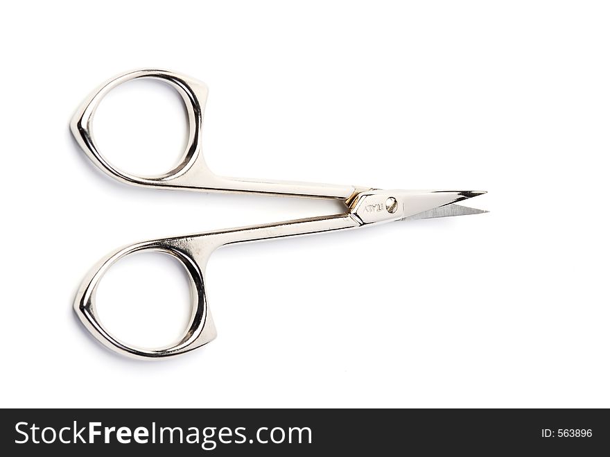 Top view of open scissors isolated on white. Focus is on the handles. Top view of open scissors isolated on white. Focus is on the handles