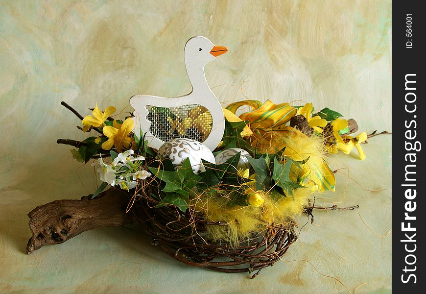 Easter table decoration, birch nest with easter eggs, yellow decoration and wooden duck. Easter table decoration, birch nest with easter eggs, yellow decoration and wooden duck