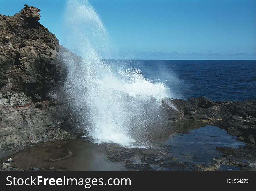 Wave crashing in a rocky Mauii beach. Wave crashing in a rocky Mauii beach.