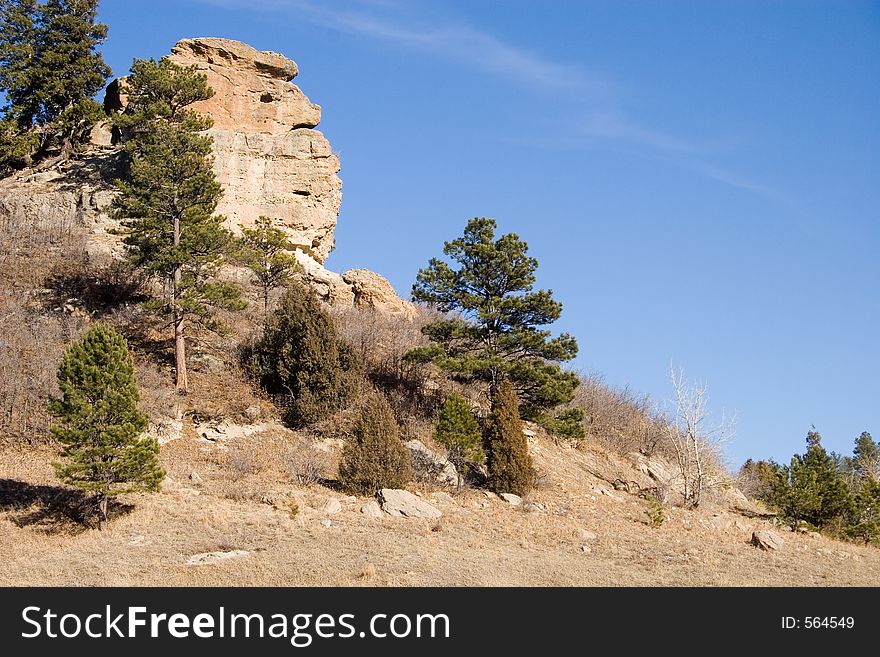 A granite rock formation in Castlewood Canyon State Park seems to take on the semblance of a face in profile overlooking a hiking trail. A granite rock formation in Castlewood Canyon State Park seems to take on the semblance of a face in profile overlooking a hiking trail.