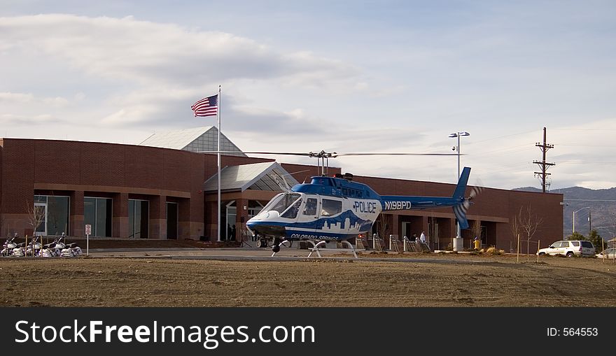 A blue and white police helicopter prepares to liftoff from a helo pad in front of a police substation in Colorado Springs. A blue and white police helicopter prepares to liftoff from a helo pad in front of a police substation in Colorado Springs