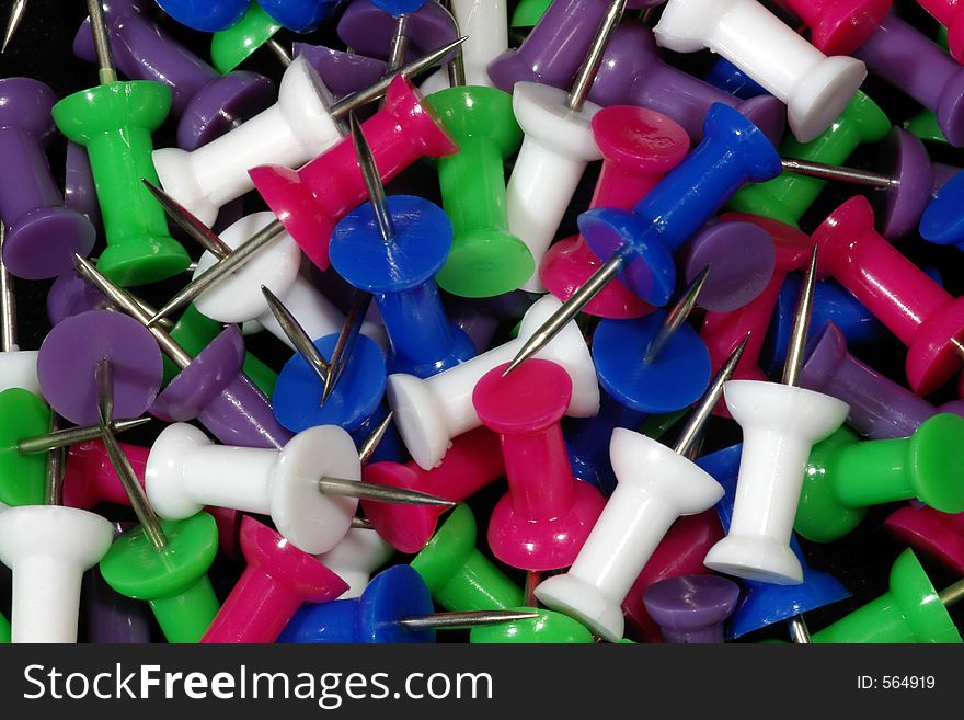 A melange of brightly colored pushpins