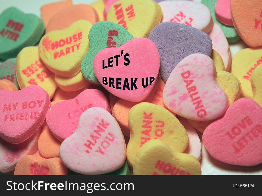 Candy hearts with sayings; pink middle heart says Let's Break Up. Candy hearts with sayings; pink middle heart says Let's Break Up.