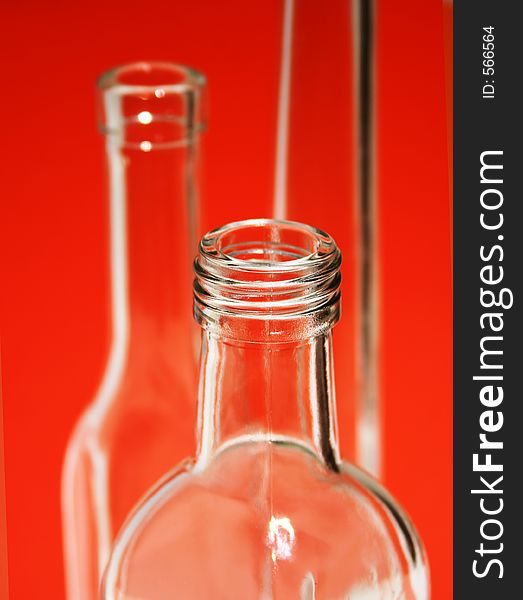 Empty glass bottles with a red background. Empty glass bottles with a red background