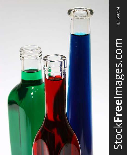 Glass bottles filled with different coloured liquid. Glass bottles filled with different coloured liquid