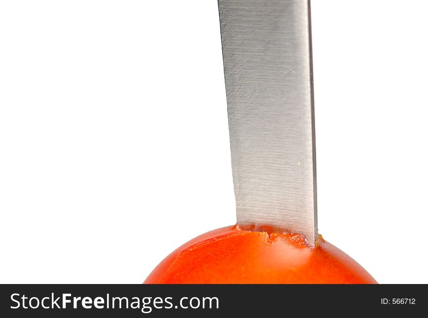 Blade stuck in a tomato. Blade stuck in a tomato