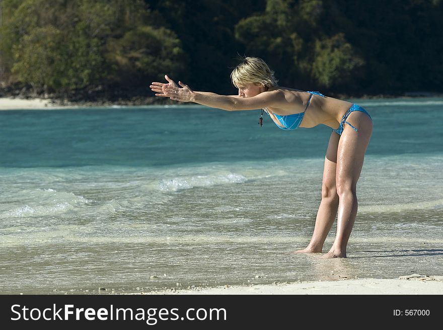 Girl stretching on the beach. Girl stretching on the beach