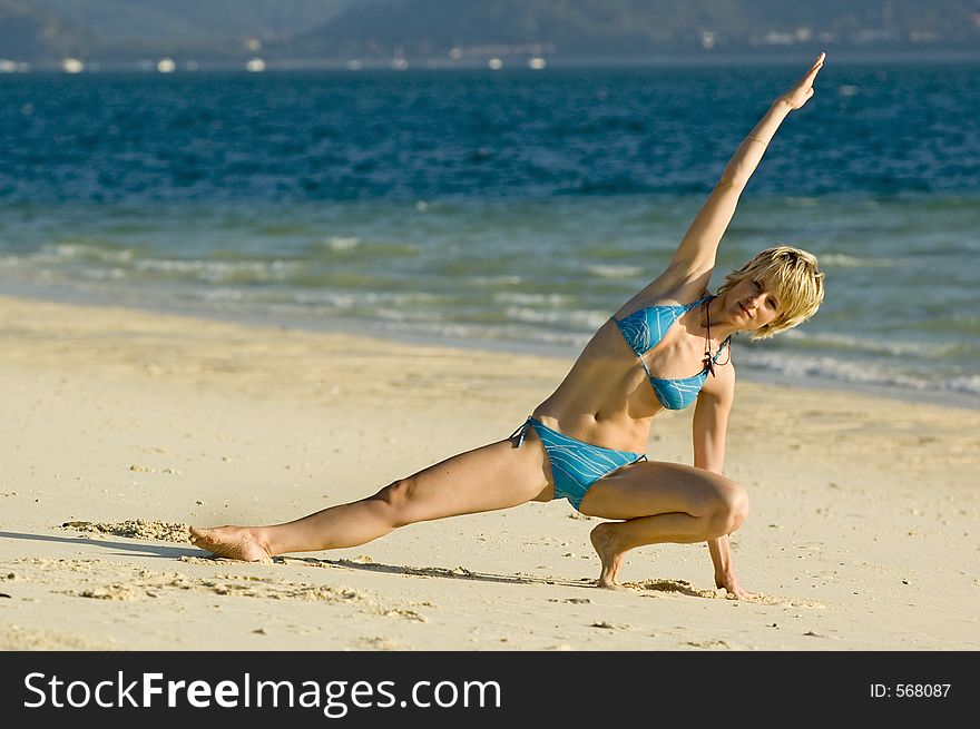 Girl stretching on the beach. Girl stretching on the beach