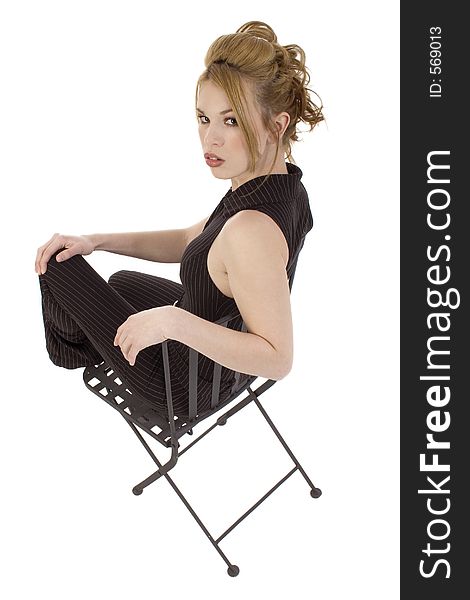 Beautiful Hispanic model sitting in black iron chair over white. Beautiful Hispanic model sitting in black iron chair over white.