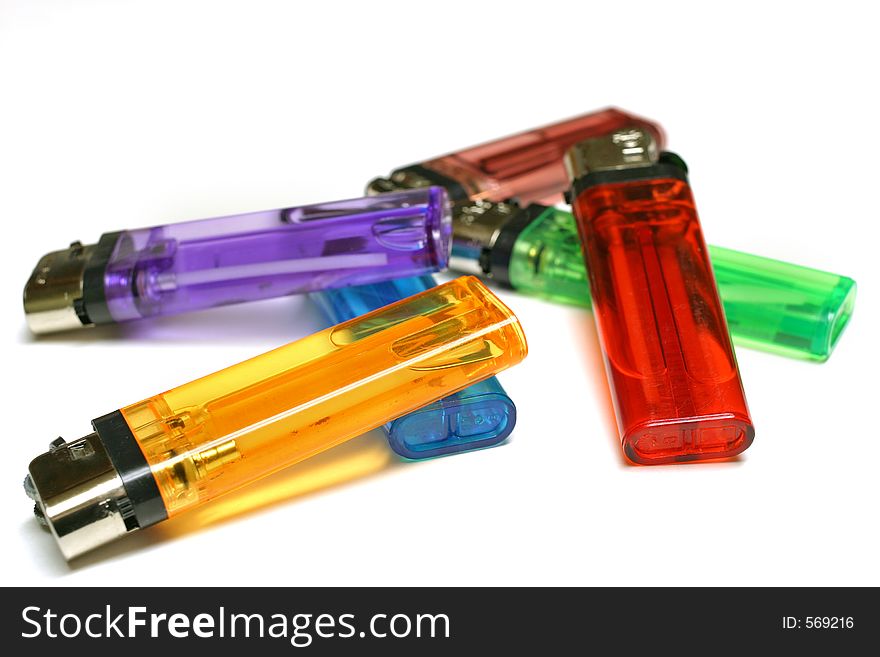 Six colorful lighters in a pile isolated on white