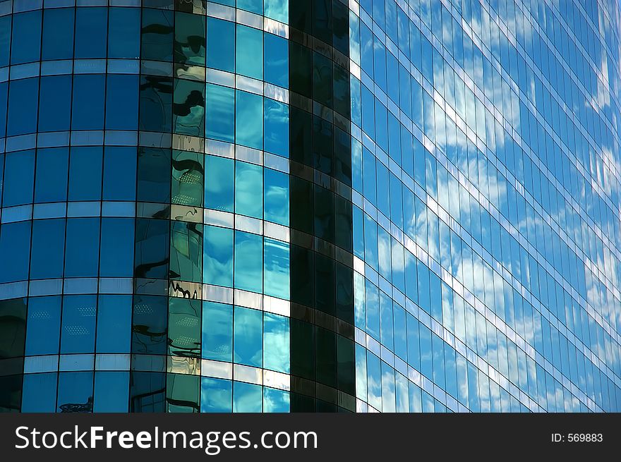 Cloudy sky reflected in glass of modern building. Cloudy sky reflected in glass of modern building