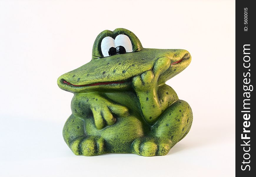 Green funny frog made of stone. Green funny frog made of stone