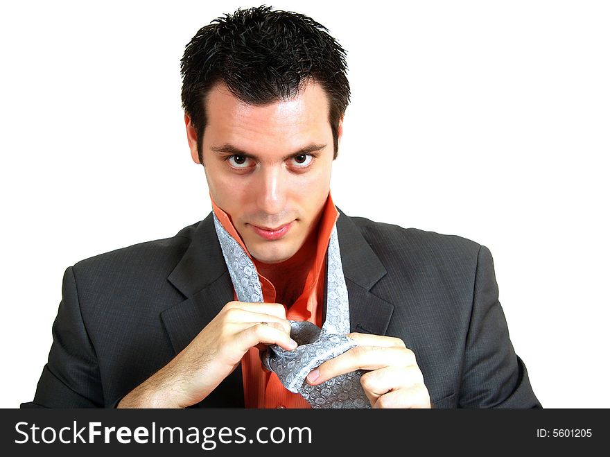 A young man, putting his tie on, dressing up for work. A young man, putting his tie on, dressing up for work